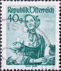 Austria - circa 1949: a postage stamp from Austria, showing a woman in national costume from the region: Vienna (1840)