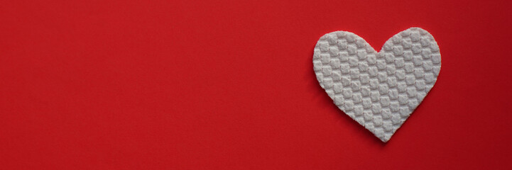 Fabric white heart on vivid red table