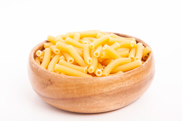  Uncooked pasta in wooden bowl on white background.