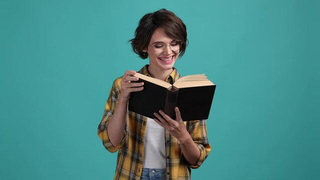 Nerd lady read interesting textbook isolated cyan color background