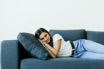 Fototapeta premium Young woman lying on comfy couch sleeping or having day nap resting alone