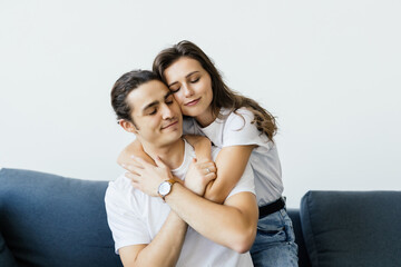 Beautiful couple, holding hands, posing for camera at home