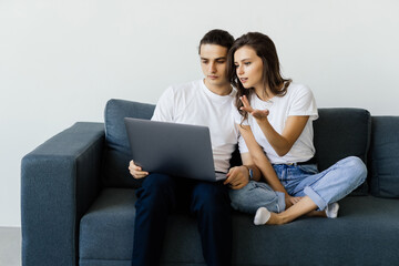 Young happy couple video calling on computer