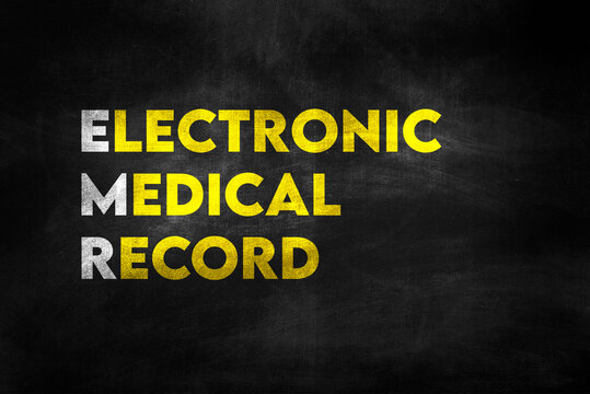 ELECTRONIC MEDICAL RECORD (EMR) written on black chalkboard with golden letters