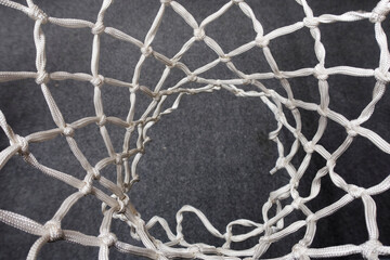 basketball hoop with a new net suspended above in a sports hall - 484629068