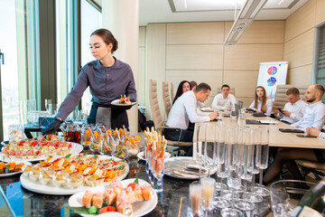 waiter serving a banquet in the office