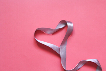 Valentine's Day. Ribbon hearts on pink background. Flat lay, top view, copy space