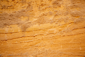 Textural sand, with  relief surface, multi-colored layers and different in size of granules, in outdoor sand career, after mining ore and sand for construction.