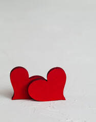 Fototapeta premium Two red hearts close up on a white background. Copy space. Valentine's Day concept.