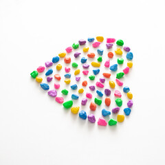  Colorful heart made of pebbles of different colors. Minimal concept of love. White background