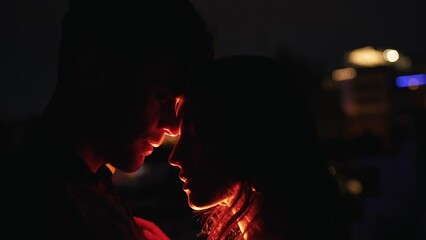 couple hugging by the light of street lamps