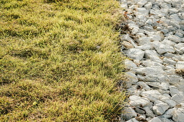 Granite stones behind a metal grate for strengthening the slope. Stones behind the wire. grey texture. construction.