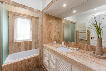 Bathroom with brown colored stone