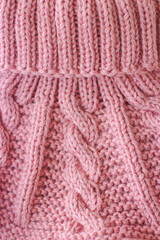 Pink knitted scarf on a white background