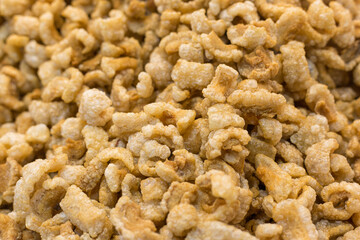 Pork crackling (pork snack, pork scratching) is fried pork skin as snack and we can eat it with noodles in Thai food style.