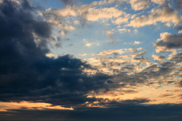 Naklejka na ściany i meble cloudy sky during sunset, thick beautiful clouds. rainy weather