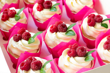 Cupcakes  decorated with fresh raspberry  in delivery paper box. Sweet food delivery. Fruits cup cakes, menu design or recipe background