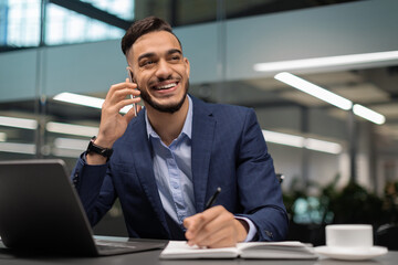 Positive arab businessman working at modern office