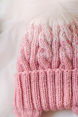 Fototapeta na wymiar Pink knitted beanie on a white background