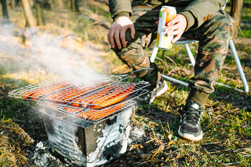 Person preparing barbecue grill in spring