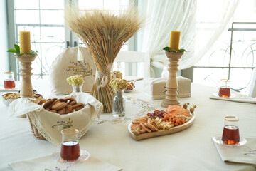 Table with orange cookies, fruits snacks.