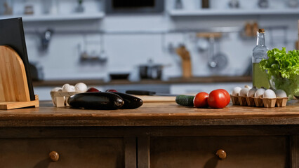 fresh ingredients and bottle with oil in modern kitchen.