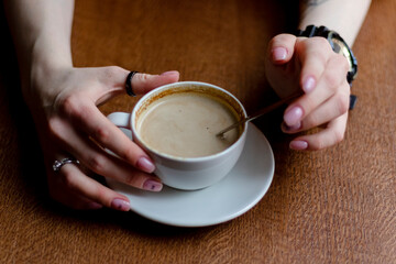 Woman in a cafe drinking coffee