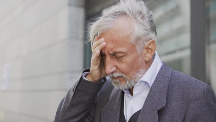 Sick mature man touching sore forehead, feeling strong headache, risk of migraine or stroke, high blood pressure, hypertension, risk of consciousness loss, emergency situation