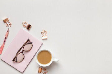 Top view of the desktop. Cup of coffee glasses notepad on the table. Flat lay copy space