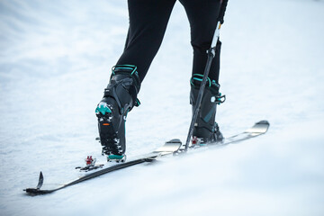 Fototapeta na wymiar Mountaineer ski walking on the snow going up to the mountain. Adventure winter sport.