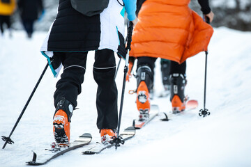 Mountaineer ski walking on the snow going up to the mountain. Adventure winter sport.