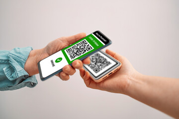 Digital covid-19 vaccination certificate on mobile phone. Covid-19 control. Coronavirus vaccinated people scan QR code visitor on entrance to public place.