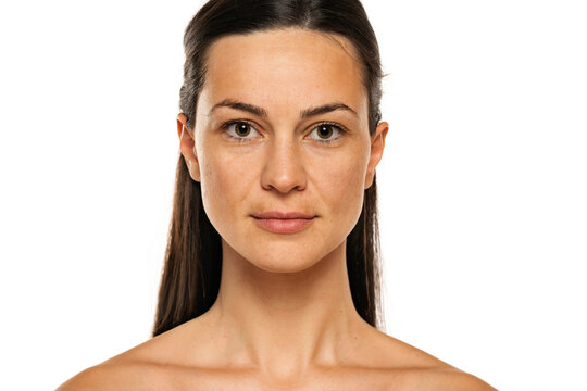 a young smiling woman without makeup with long hair on a white