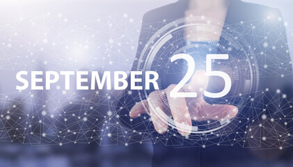 September 25th. Day 25 of month, Calendar date. Hand click luminous hologram calendar date on light blue town background. Autumn month, day of the year concept.