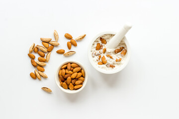 Pestle almond flour - nuts with mortar on kitchen table