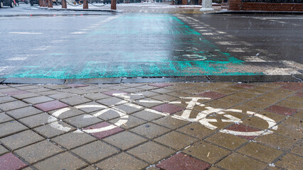 Concept traffic sign. White bike lane sign on wet sidewalk. Bicycle markings.