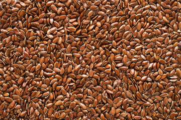 Linseed or flaxseed background, brown flax seeds. Flat lay, copy space - obrazy, fototapety, plakaty