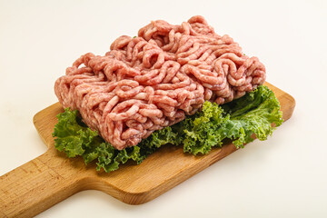 Raw pork minced meat over board