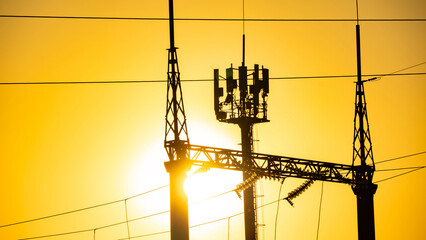 Production of fuel and electricity.Electrical networks with wires and transformers at sunset.Power...