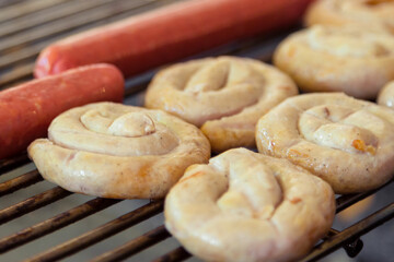 Grilling sausages on barbecue grill.
