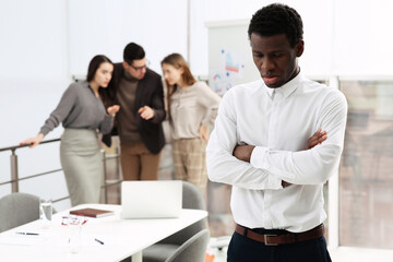 Fototapeta premium African American man suffering from racial discrimination at work