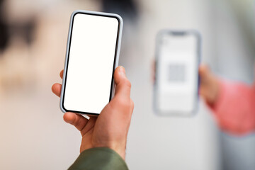 Male Hand Holding Cellphone Scanning Code On Phone Indoors, Closeup