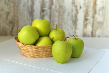 Juicy green apples in a basket