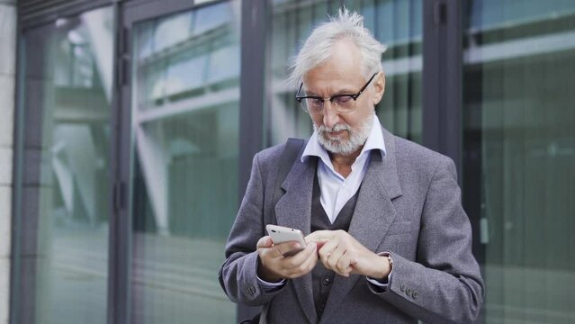Male office worker betting and winning in online application on his smartphone