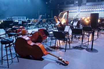 Musical instruments - two double bass or contrabass are in the orchestra room. In pending of the musicians before the rehearsal. - obrazy, fototapety, plakaty