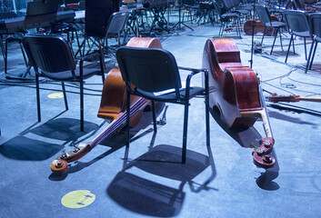 Musical instruments - two double bass or contrabass are in the orchestra room. In pending of the musicians before the rehearsal.