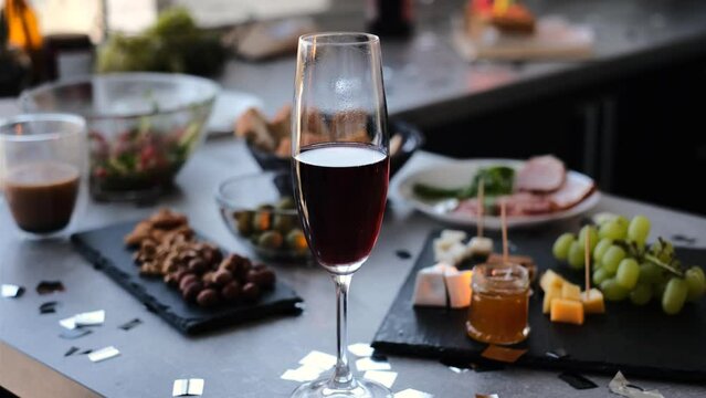 festive table with a glass of champagne and snacks woman drinking champagne