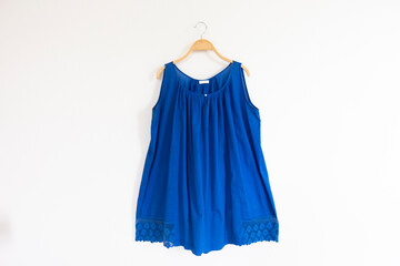 Blue dress on hangers.