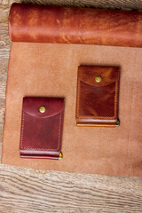 Money clip made of genuine leather on a leather background