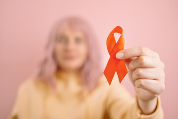 Woman hand holding red ribbon for december world aids day, Cancer Awareness month. Health care and...